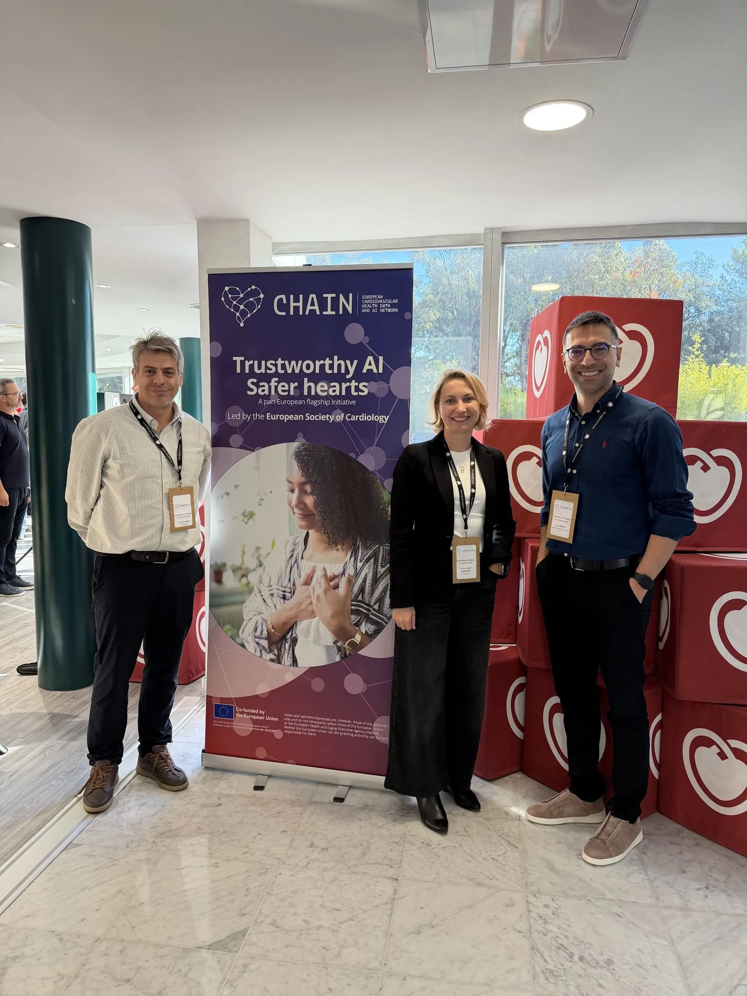 The Pontegra team at the CHAIN kick-off, standing next to a CHAIN banner that reads “Trustworthy AI, safer hearts”